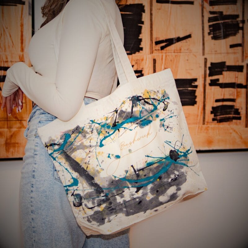Bushwick Gallery Handmade Tote Bags – Unique, Artistic, and Community-Driven Discover the one-of-a-kind handmade tote bags from Bushwick Gallery, located in the heart of Bushwick, Brooklyn, a vibrant and growing artist community. Each tote is crafted with care, offering you the chance to own a truly unique piece. Choose between a simple plain tote or an exclusive artist-used tote, touched by the hands of artists as they create their masterpieces. No two bags are the same—every artist-used tote carries its own distinct marks from the studio, making it a true work of art. 100% of the profits from these bags go towards supporting artists, helping them display their work at Bushwick Gallery. By purchasing one of these totes, you are directly contributing to an artist’s journey, giving them the platform to share their creations with the world. Product Features: • Handmade & Unique: Every artist tote is individually crafted, making each one one-of-a-kind. • Location: Designed and influenced by the dynamic art scene in Bushwick, Brooklyn, a creative hub where new and established artists thrive. • Size: 18.5" x 15" – spacious and versatile for everyday use. • Material: 100% cotton canvas, durable for a range of uses. • Style Options: Choose between a plain, sleek tote or an artist-used tote with unique studio marks. A Perfect Gift for Art Lovers and Supporters These handmade tote bags make ideal gifts for art lovers, gallery goers, or anyone who wants to feel connected to the art world. When you purchase a Bushwick Gallery tote, you’re doing more than just carrying a bag—you’re supporting the creative spirit of Brooklyn’s thriving artist community. Be part of Bushwick, a place where art comes alive, and creativity knows no bounds. • Handmade tote bags • Artist tote bags • Unique Brooklyn tote bags • Art community tote bag • Bushwick Brooklyn art • Support local artists • One-of-a-kind artist totes • Bushwick Gallery Brooklyn • Brooklyn artist gifts • Tote bags for art lovers Explore Bushwick, Brooklyn’s Art Scene Located in Brooklyn’s cool, up-and-coming Bushwick neighborhood, this community is home to a diverse range of artists who push the boundaries of creativity. With galleries, studios, and art spaces emerging every day, Bushwick is the new heart of New York City’s contemporary art scene. Owning one of these bags connects you to this exciting world and lets you carry a piece of Bushwick’s creative energy with you.